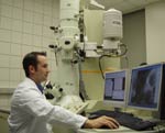 A scientist operating an electron microscope
